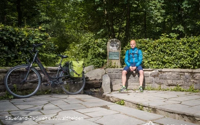 Udo sits at the source of the Ruhr near Winterberg.